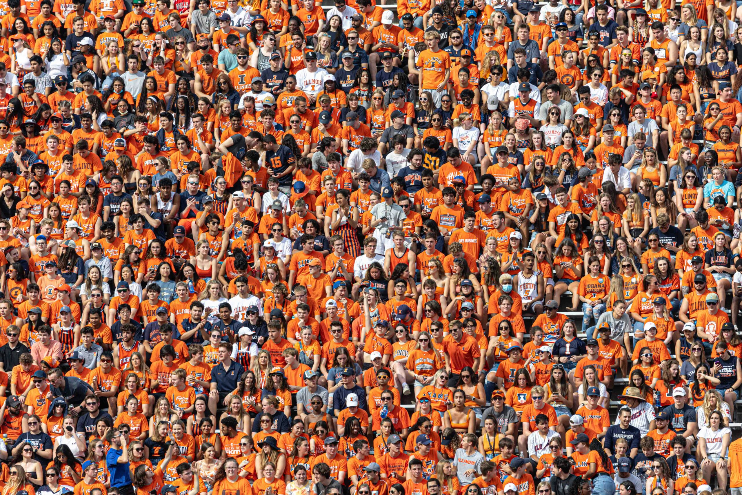 Fans wearing orange in their football stadium seats